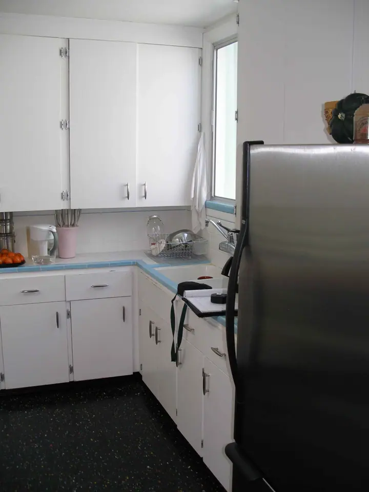 A striking change of style in this complete kitchen remodel: Before sink area
