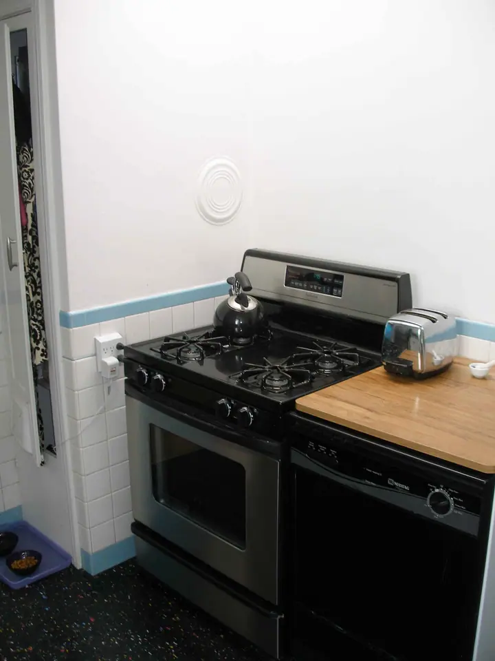 A striking change of style in this complete kitchen remodel: Before stove corner