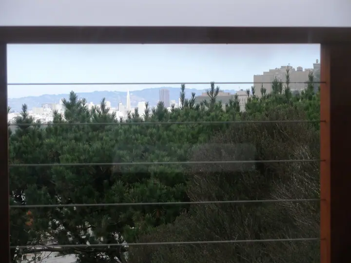 Cable rail system with redwood posts in Twin Peaks, San Francisco: viewq through cable