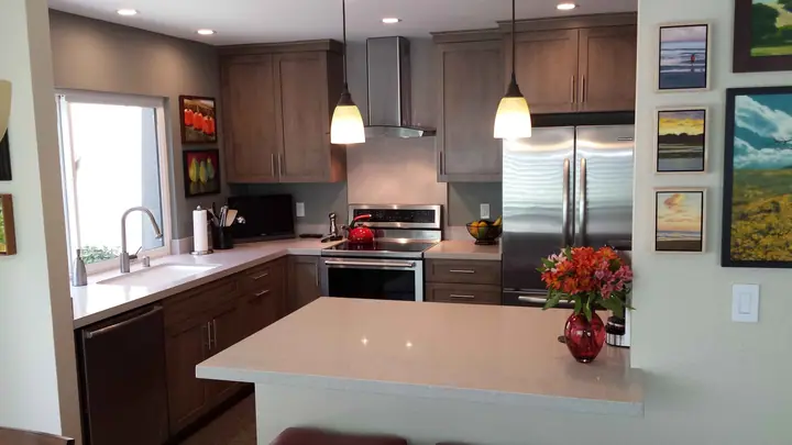 Remodeled Novato kitchen with an island, pendant lights and stainless appliances