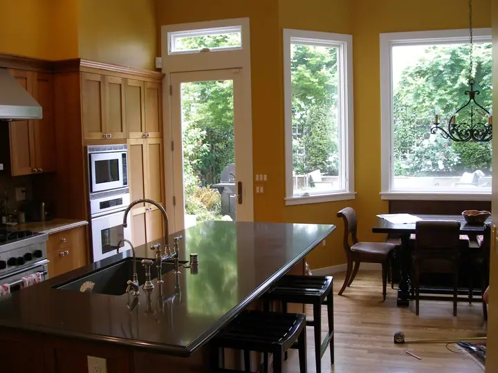 Kitchen and dining bay addition with new island, crown and TV alcove: the back door and bay
