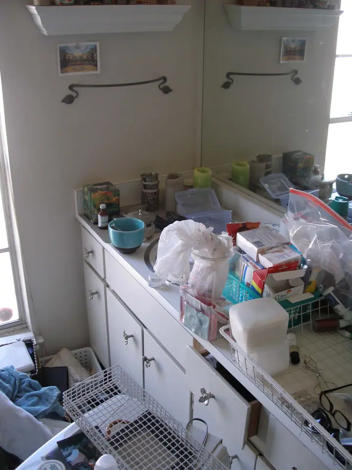 Penthouse primary bath reorientation with glass tile in Oakland: Before mast bath vanity east end