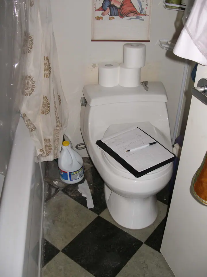 Penthouse primary bath reorientation with glass tile in Oakland: Before Tub shower toilet closet west end