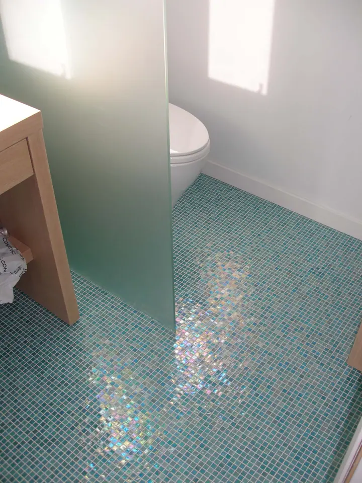 Penthouse primary bath reorientation with glass tile in Oakland: toilet west end