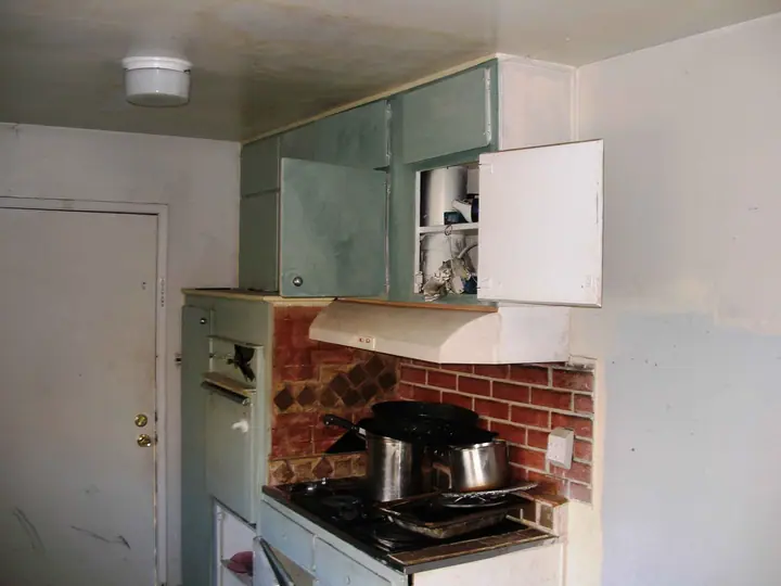 Rental kitchen that was in bad shape, Novato: Before range wall
