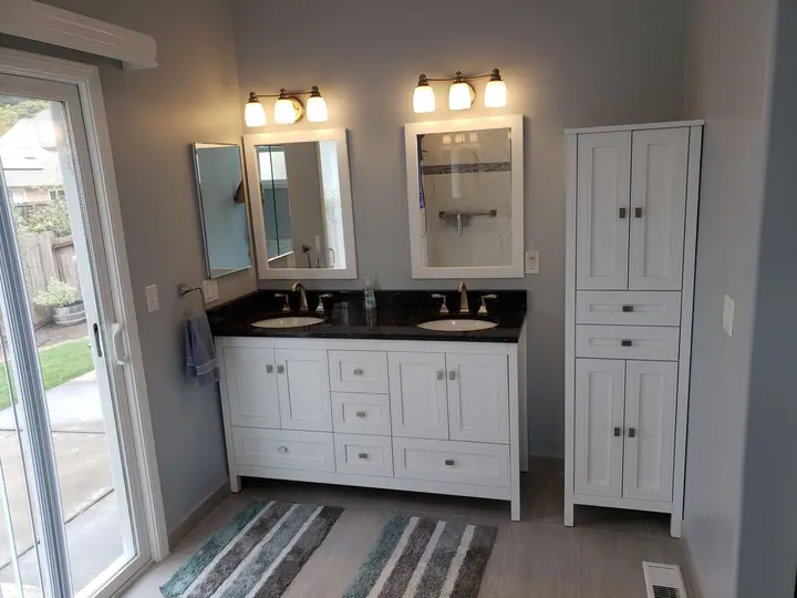 Remodeled bathroom in Santa Rosa with a double vanity and a linen cabinet
