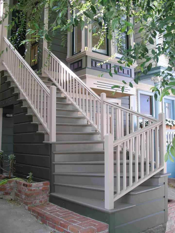 Painted Victorian entry stairs with turned balusters and a newel post